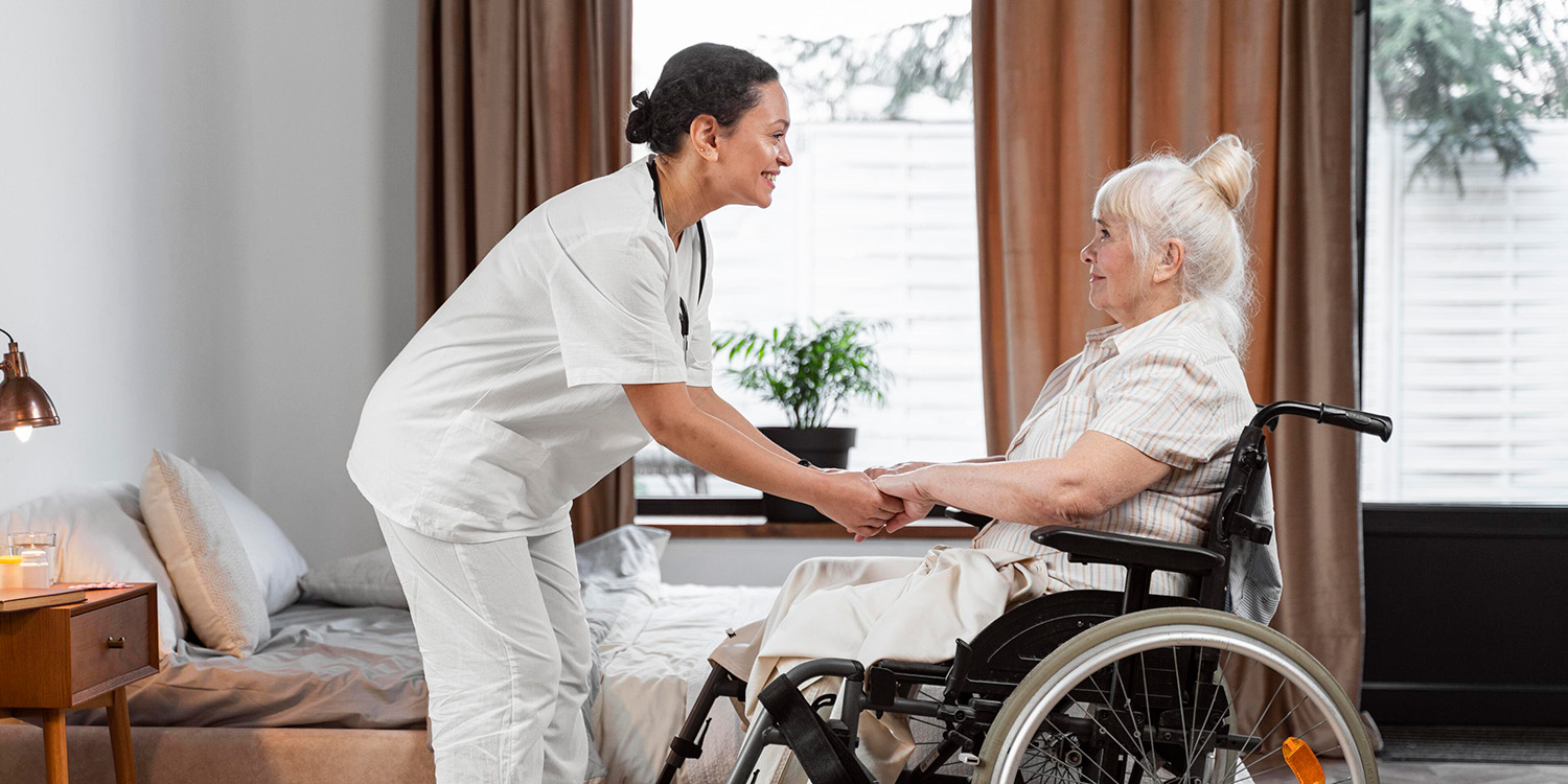 A loving compassionate caregiver speaks to an elderly woman in an in-home care setting.